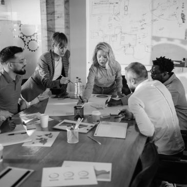 A group discussing ideas around a table in an office.