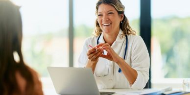 Smiling doctor consulting with patient.
