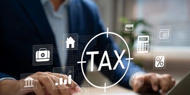 Businessman calculating taxes with digital icons representing financial concepts.