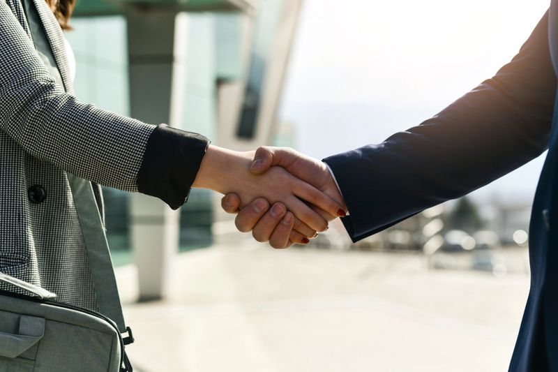 Female and Male Handshaking Marking Conclusion of Successful Job Interview