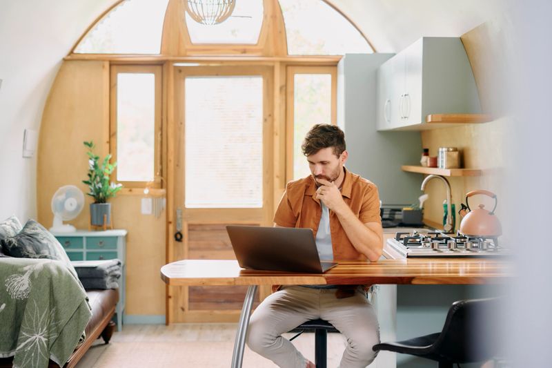 Freelancer, man and thinking with laptop for article, research information and proofreading story. Home, remote work and male journalist with digital for news credibility, structure and blog ideas