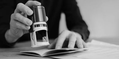 Person stamping a document.