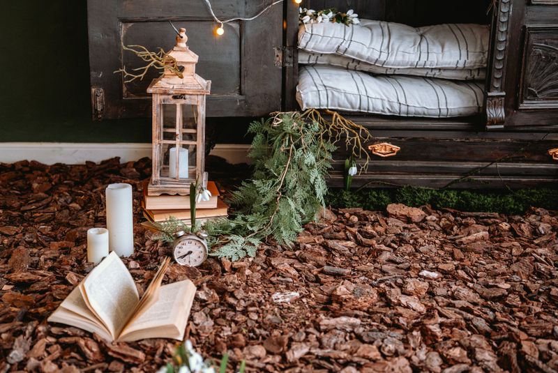 A comfortable corner features books, candles, and greenery for a peaceful atmosphere.
