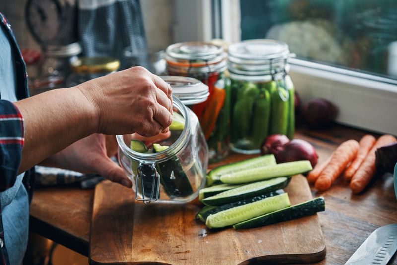 Fermented Foods - Preparing Fermented Cucumbers with Spices and Filled in a Jar