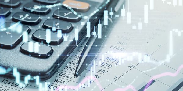 Calculator, pen, and financial charts on paper representing data analysis.