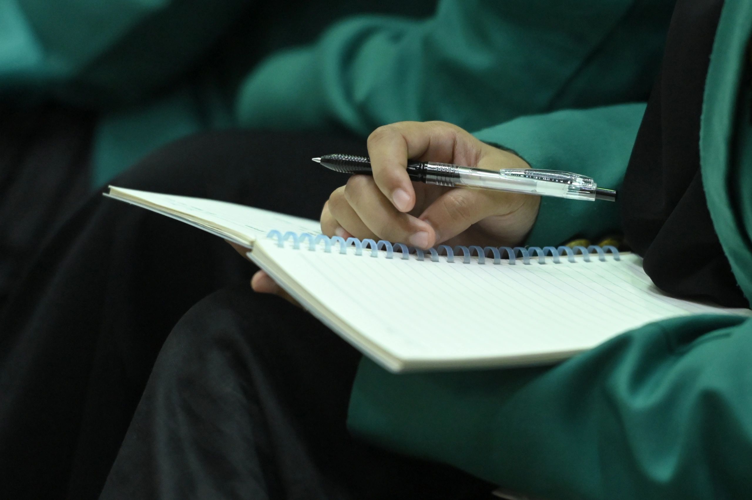 torso and hand of a person journaling