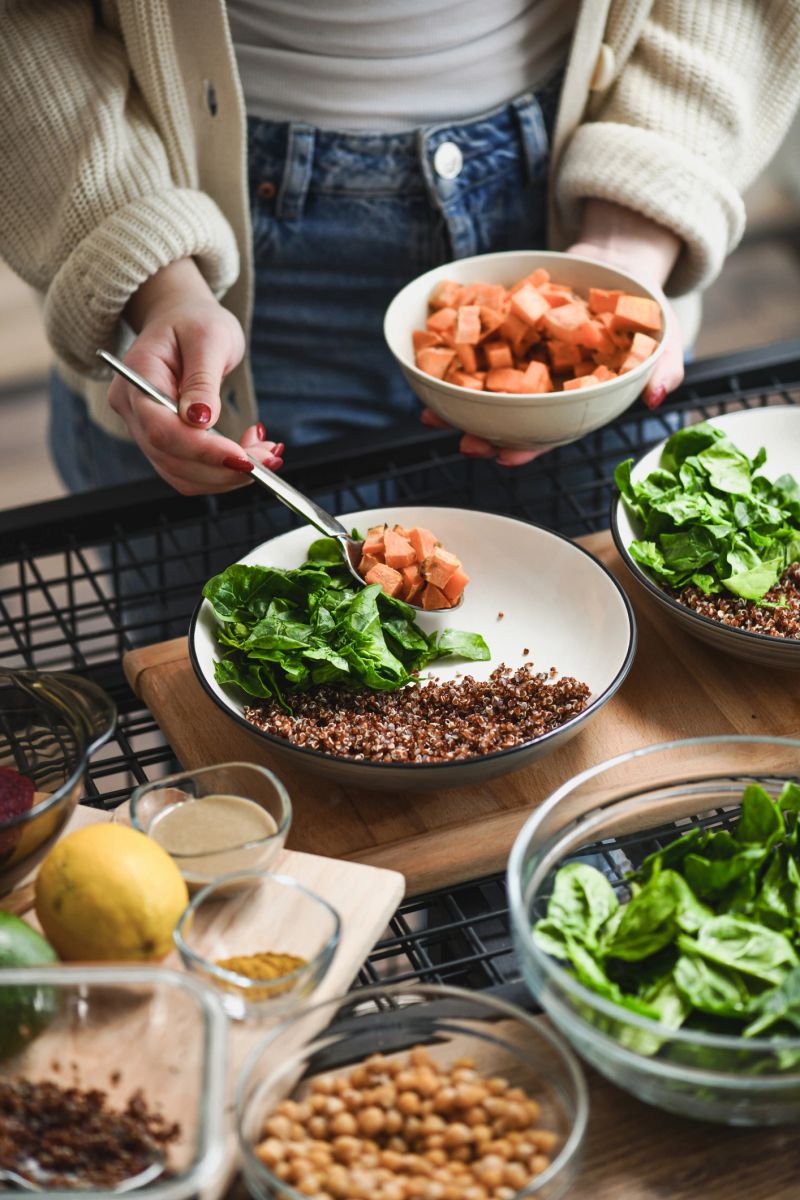 Female Creating Aesthetically Pleasing Buddha Bowls With Colorful Nutritious Ingredients