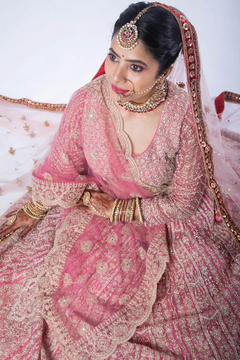 Close-up portrait of beautiful bride in traditional dress and jewelry posing during wedding ceremony