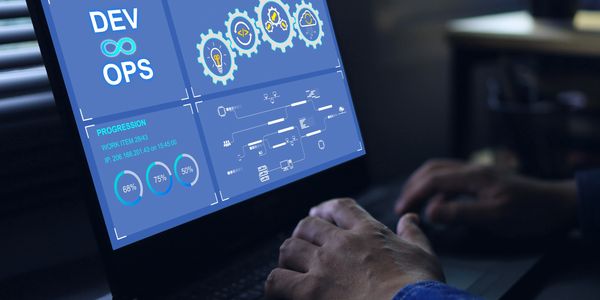Person working on DevOps dashboard on a laptop.