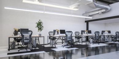 Modern office space with ergonomic chairs and desks.