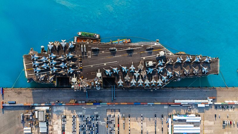 Aerial top view aircraft carrier park for loading oil from tanker ship on the sea.