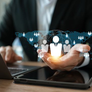 Businessman holding digital icons of global network and user connections.