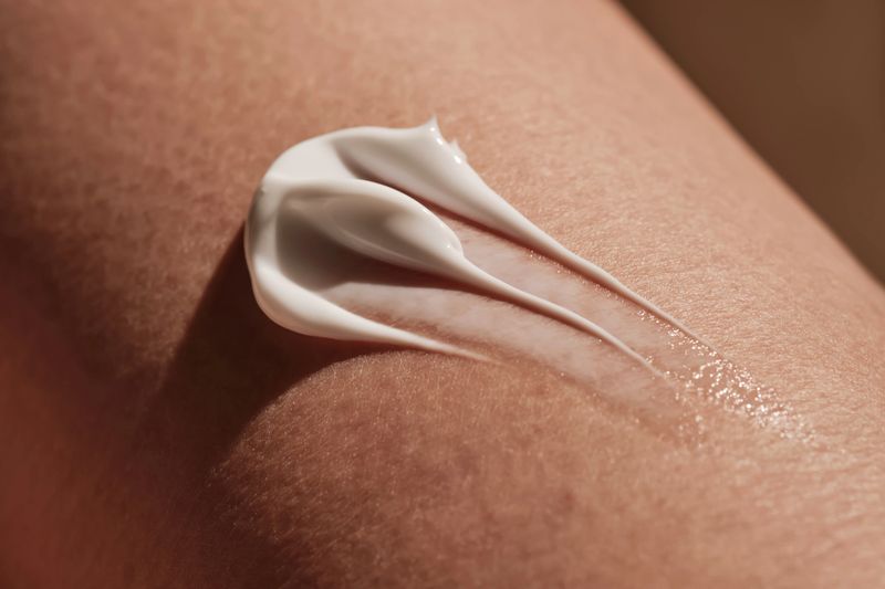 White body cream on human skin. High quality photo.