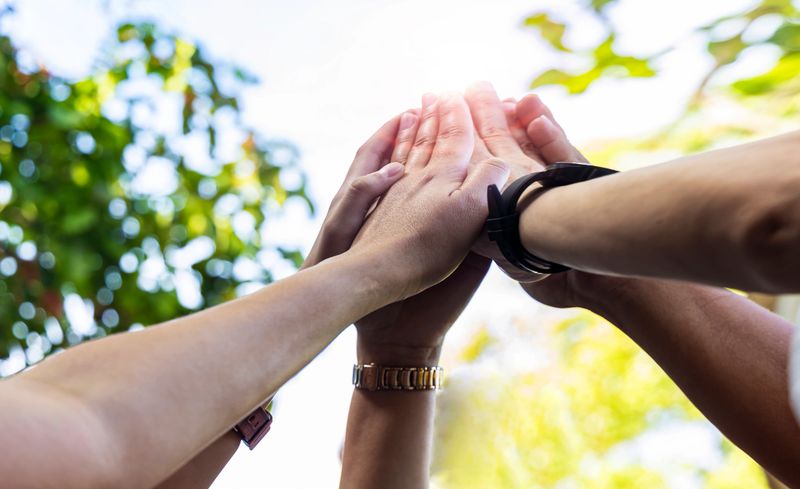 Teamwork Concept,Group of diversity people to greeting power tag team,Teamwork Join Hands Partnership Concept of people putting their hands together,Friends with hands showing unity.