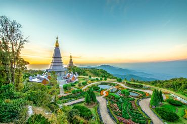 Peaceful temple and garden at sunset in mountains.