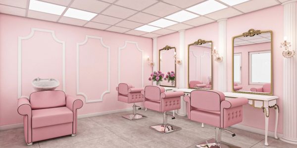 Elegant pink beauty salon interior with mirrors and chairs.