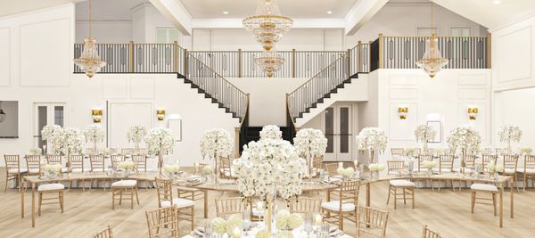 Elegant wedding reception hall with white floral centerpieces and chandeliers.