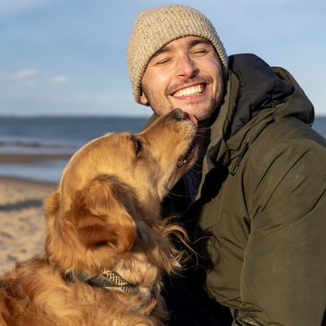 Man playing with his dog after having energy from testosterone replacement therapy for men in Owasso