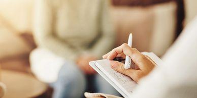 A therapist taking notes during a session.