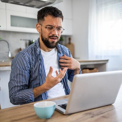 Man frustrated during a video call at home.