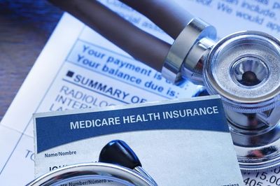Medicare health insurance card with a stethoscope on medical documents.