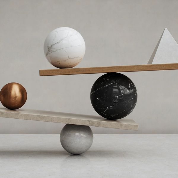 Abstract balance sculpture with spheres and a triangle in neutral tones.