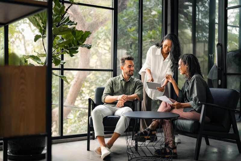 Group of busy happy diverse professional business team people working in office using digital tablet. Multiethnic young startup team working on a project together