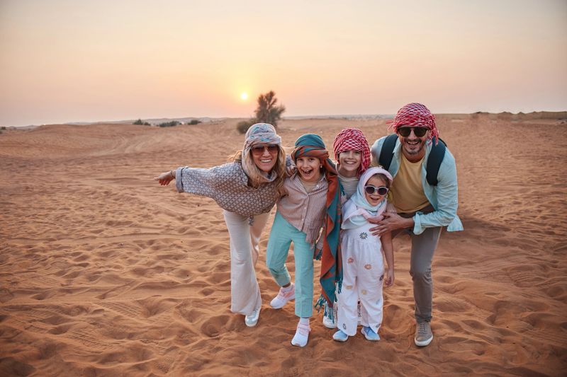 Beautiful family in Dubai desert. Vacation mood.