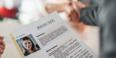 Person holding a resume during an interview.