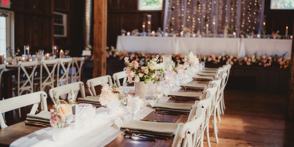Romantic wedding reception hall with elegant floral table centerpieces