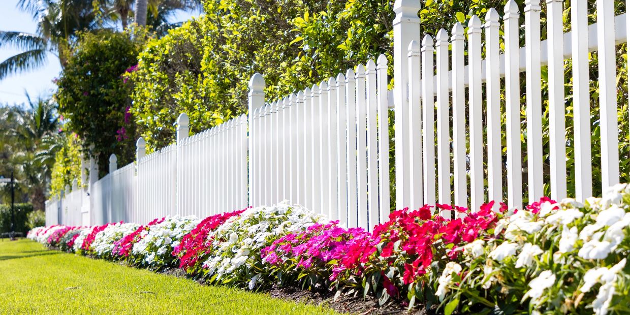 White fence with flower bed