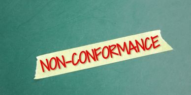 Tape with 'NON-CONFORMANCE' written in red on teal background.