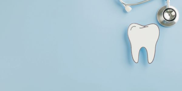 dentist kicked bakc at desk with phone
