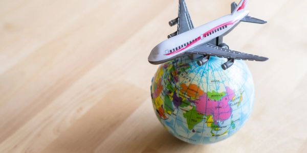 A miniature of airplane on the globe.