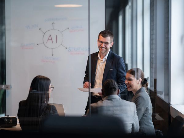 Business team discussing AI strategy in a modern office meeting.