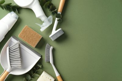 Various cleaning tools on a green surface.