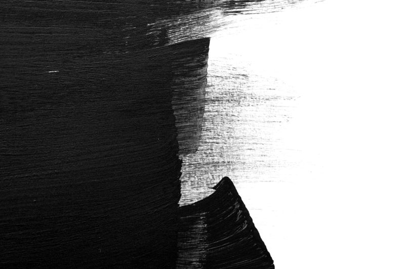 A high-contrast abstract composition featuring bold black and white paint brushstrokes. The rough texture and expressive movement create a dynamic and artistic visual, evoking themes of contrast, creativity, and modern design.