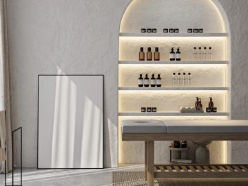 Minimalist spa room with backlit shelves and a treatment table.