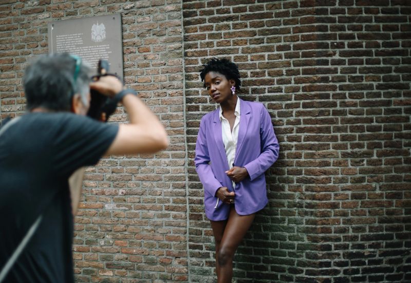 Amsterdam city lifestyle. A photographer is taking images of a lovely fashion model on the streets of Amsterdam.