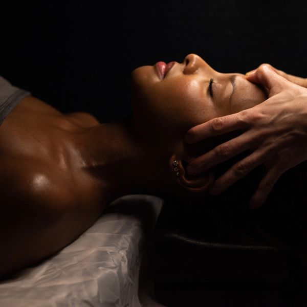 A woman receiving a gentle head massage.