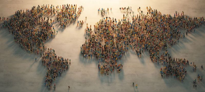 A diverse crowd of people forms the shape of a world map, all facing a central light source, symbolizing unity, hope, and a shared future.