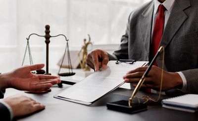 Lawyer explaining legal documents to a client in office.