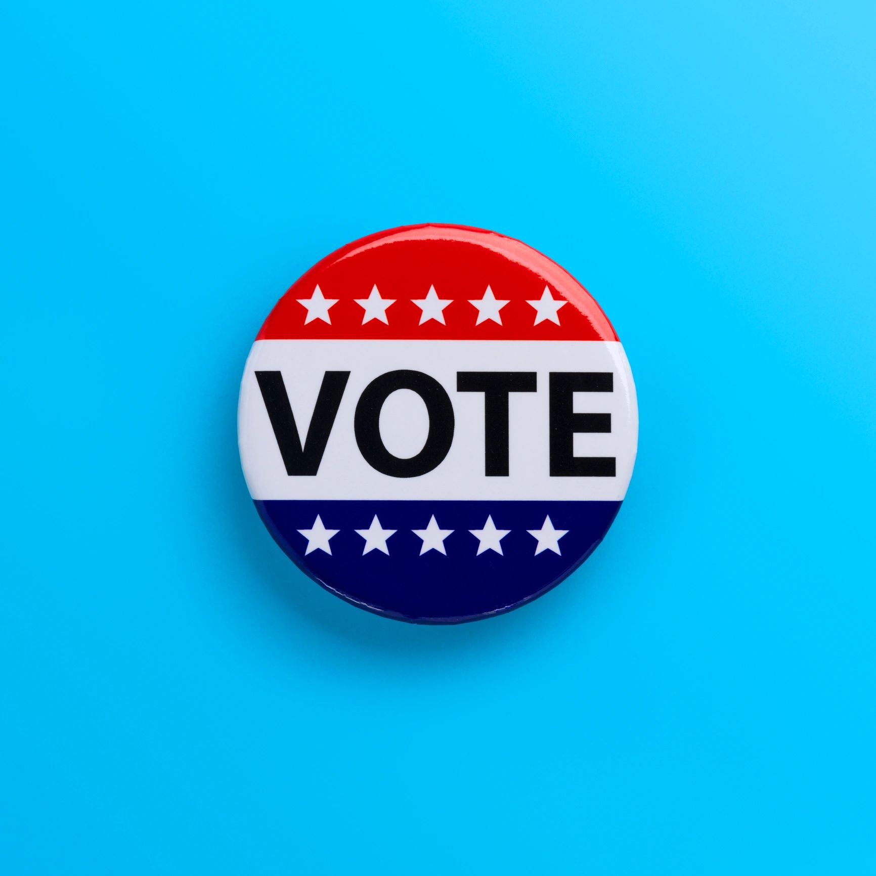 A patriotic vote button with stars on a blue background.