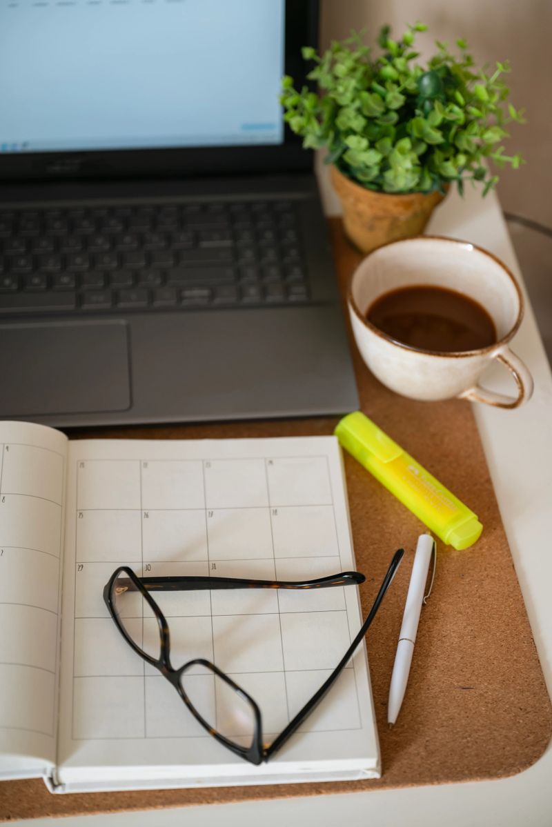 Planner notebook and cup of coffee on shadows background