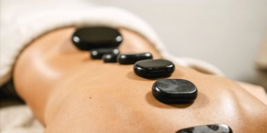 Hot stones placed on a person's back during a spa treatment.