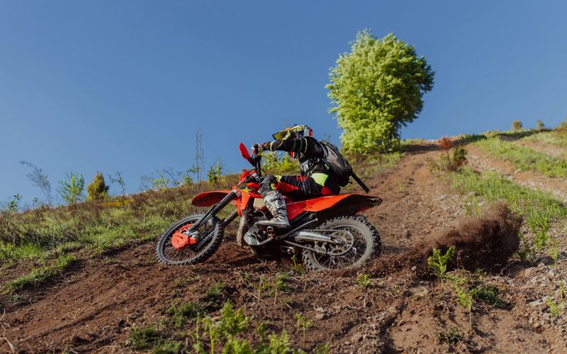 Professional enduro bike rider on action, dirt ride on the muddy road. Motocross sport. . High quality photo