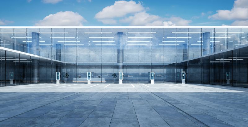 Sleek ev charging stations stand ready in front of a modern glass building, symbolizing sustainable transportation and urban innovation. 3D rendering