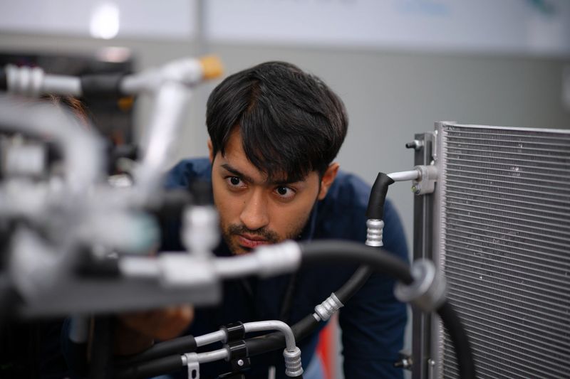 Mechanics are working at EV car workshop. Engine and parts at EV car workshop.