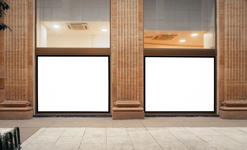 Modern billboard out of home (OOH) advertising poster template on building, in front of sidewalk. Two horizontal mock up templates side by side in street of Buenos Aires. Clean design.