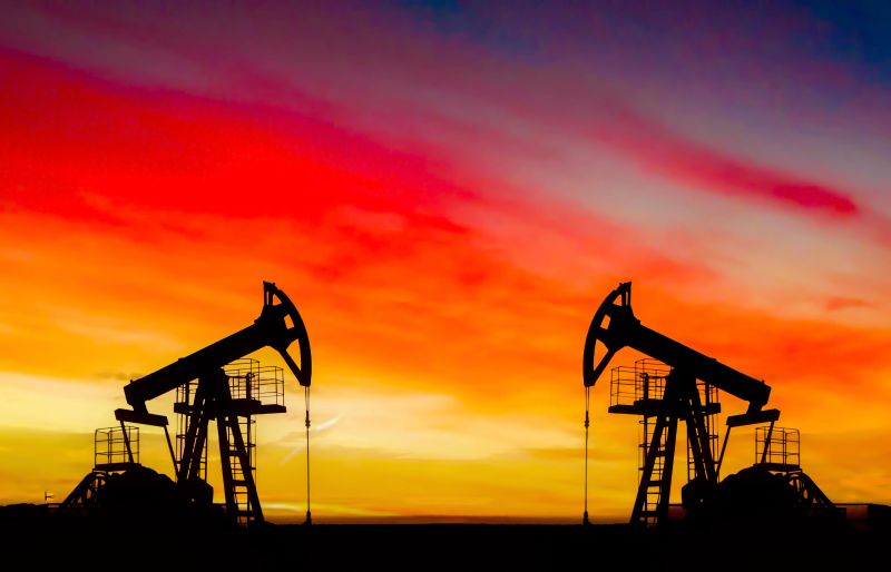 Crude oil Pumpjack on sunset. Fossil crude output and fuels oil production. Oil drill rig and drilling derrick. Global crude oil Prices, energy, petroleum demand (OPEC+). Pump jack at oilfield.